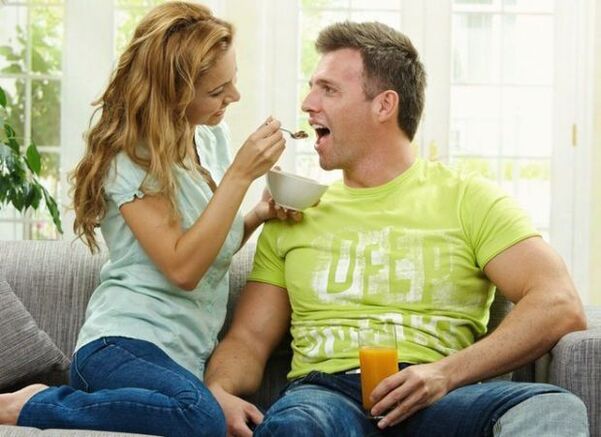 a woman feeds a man products to increase potency
